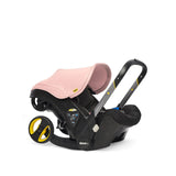 Blush pink Doona car seat side view.