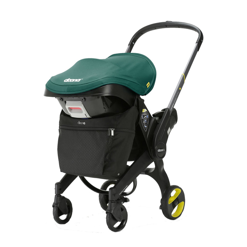 Doona stroller with large black clip on bag attached.