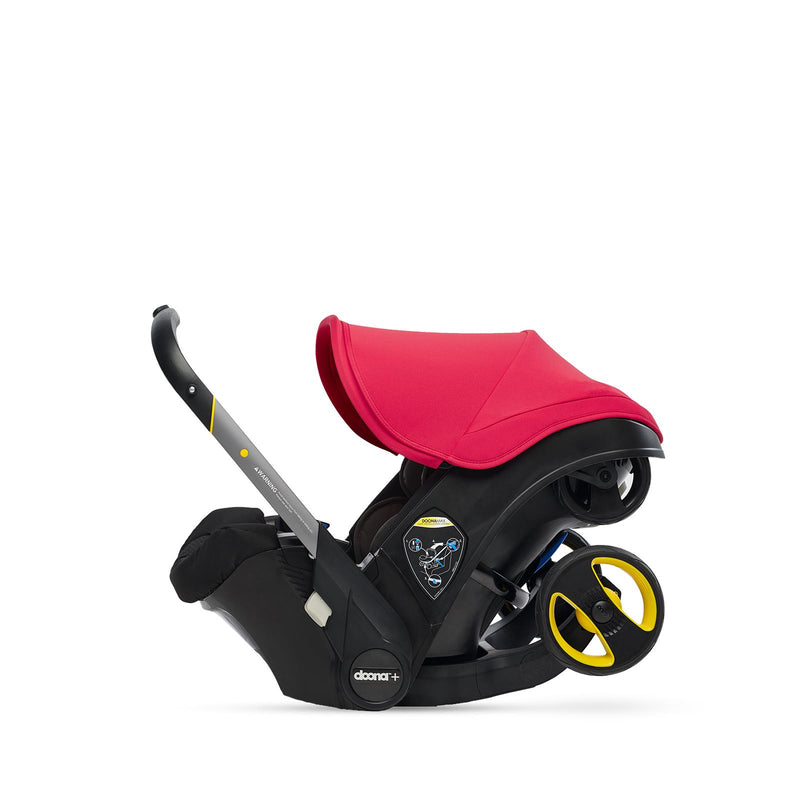 Flame red Doona car seat with handle pulled up