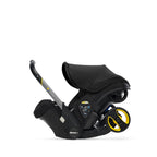 Doona nitro black car seat with handle pulled up