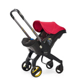 Doona stroller in flame red with handle pulled up