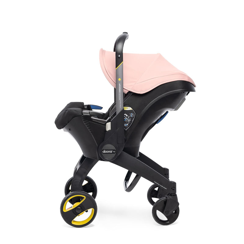 pink doona stroller from the side with handle down