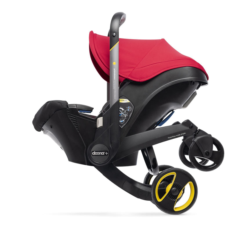 Doona red stroller folding into a car seat.